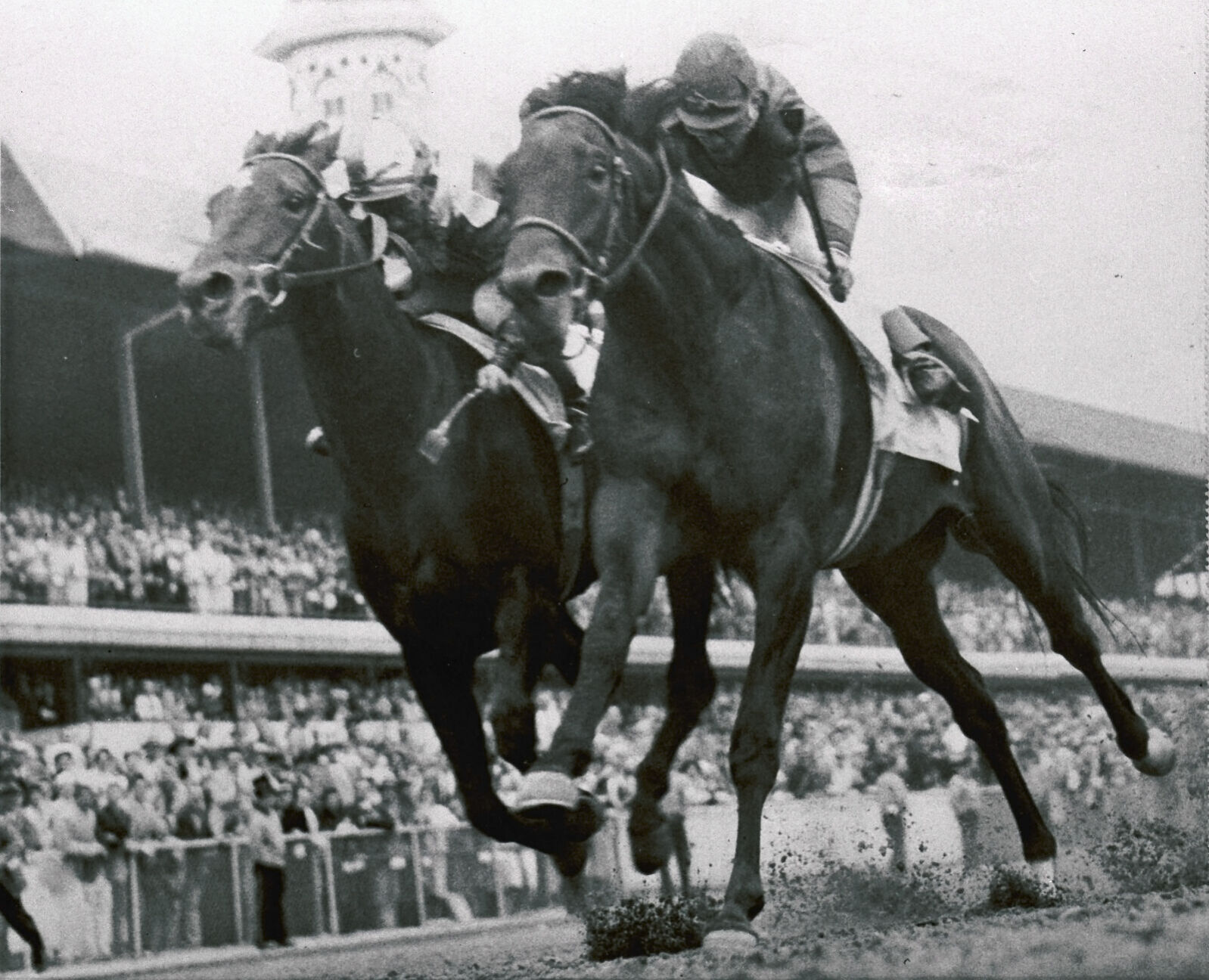 1957: Iron Liege, ridden by Bill Hartack, wins Kentucky Derby by a nose